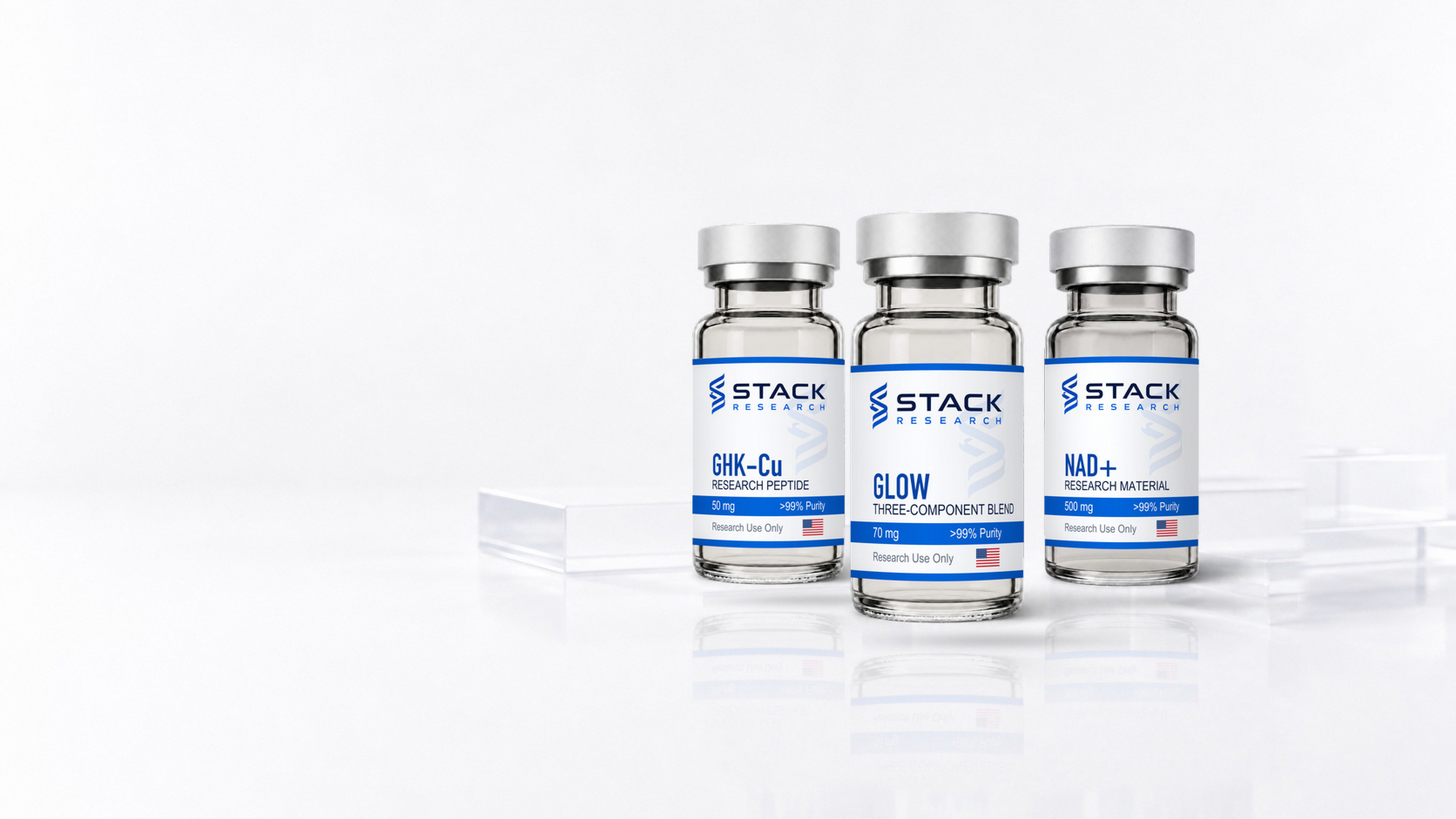 Stack Research GHK-Cu and GLOW research peptide vials with an NAD+ research compound vial in a bright studio arrangement